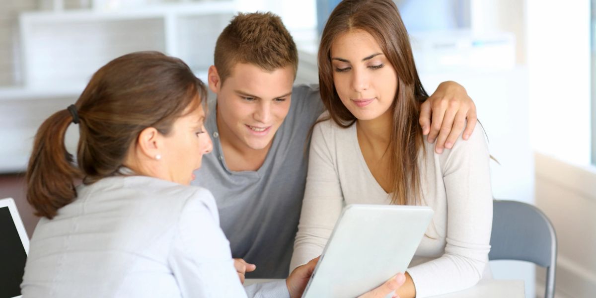 Couple reviewing a document with an advisor
