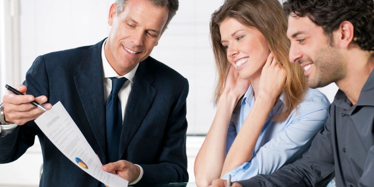 Agent going over paperwork with a couple